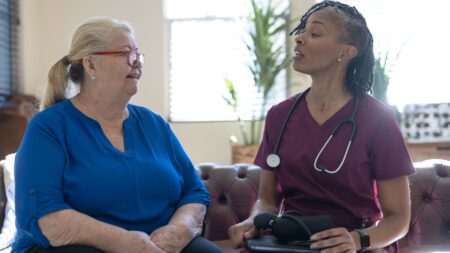 A hospice patient and nurse speaking about the complementary therapies offered by hospice, including aromatherapy, pet therapy and music therapy - Three Complementary Therapies Available in Hospice Care - Northern Illinois Hospice